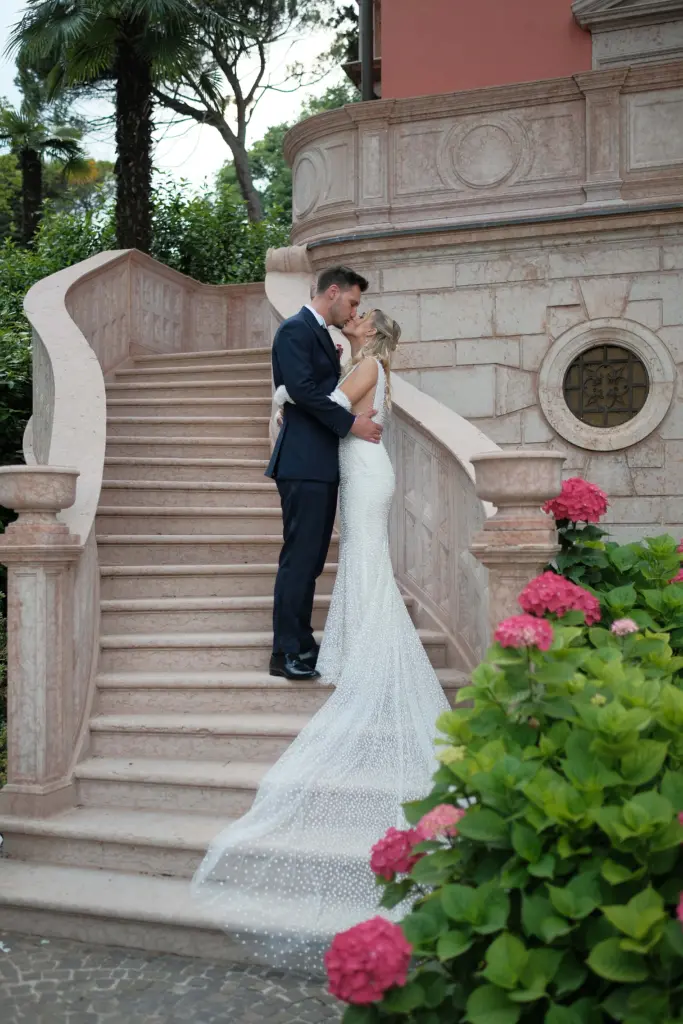 Matrimonio a Villa Fiordaliso, Lago di Garda – bacio degli sposi sulla scalinata della villa